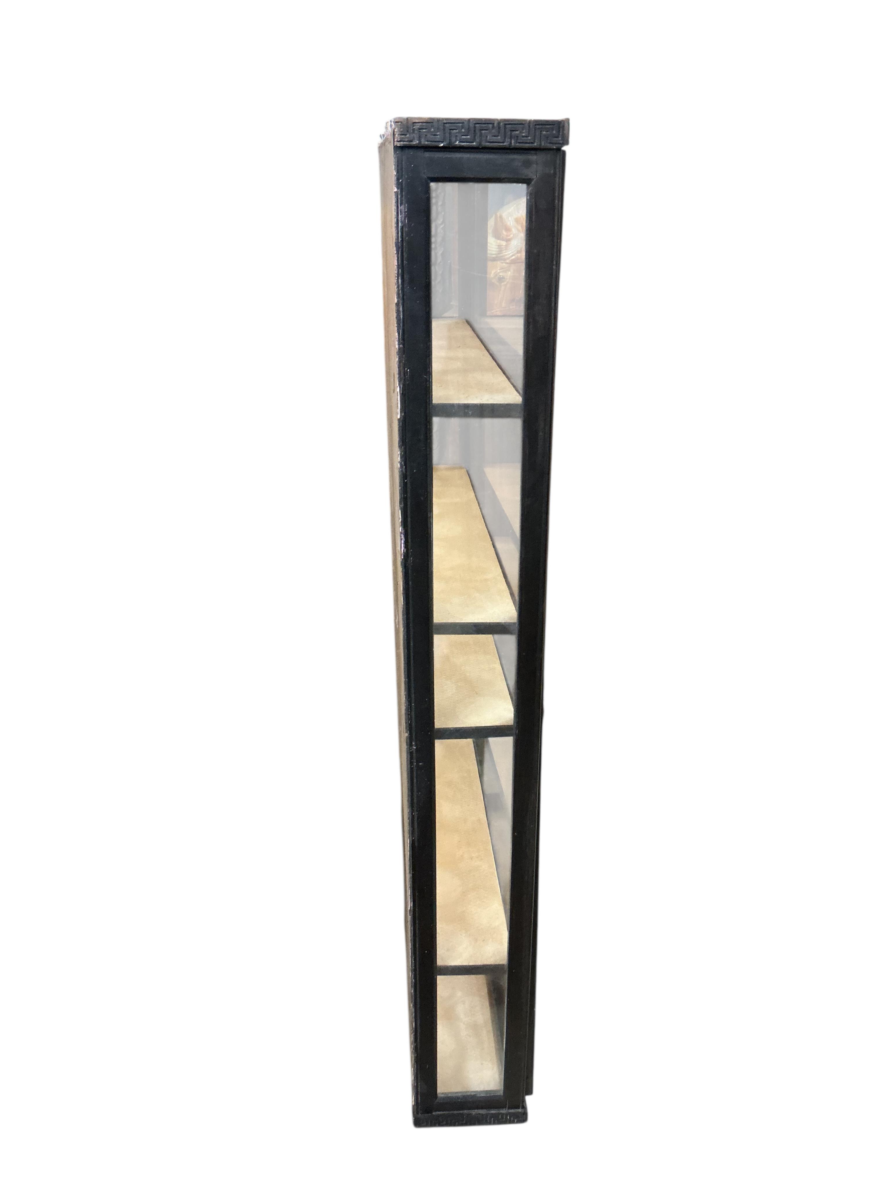 A Regency style ebonised wall cabinet, width 70cm, depth 15cm, height 122cm